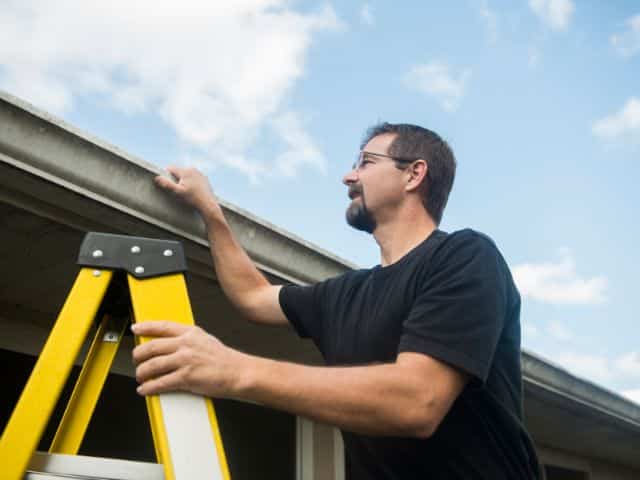 roofer inspects roof to supplement claim