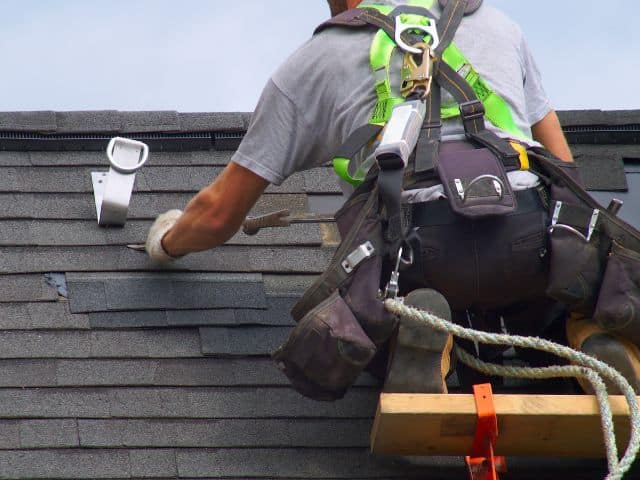 contractor repairs roof after storm damage