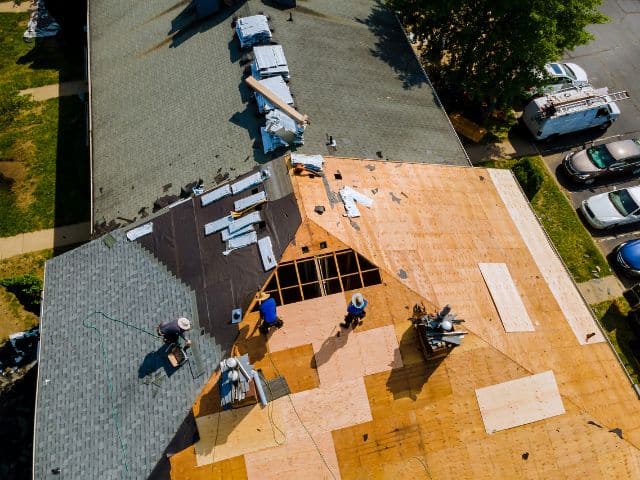 shingles being installed to roof decking